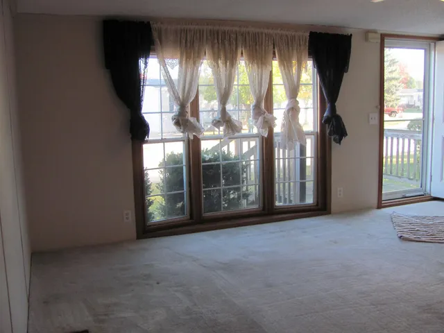 a view of an empty room with windows and city view