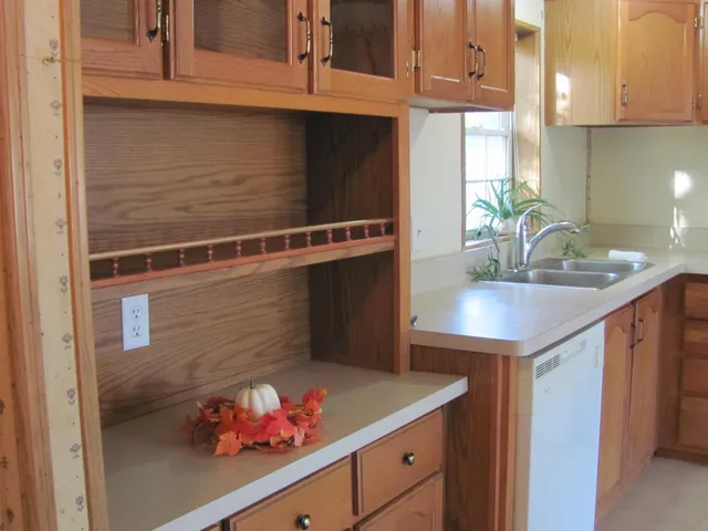 a kitchen with a refrigerator and cabinets