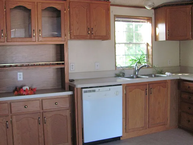 a kitchen with cabinets and window