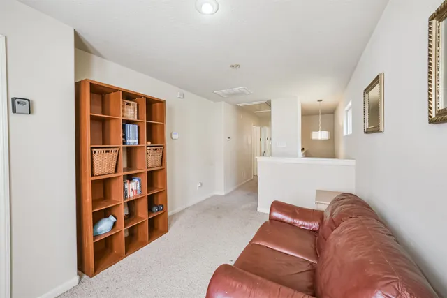 a living room with furniture cabinets and a book shelf