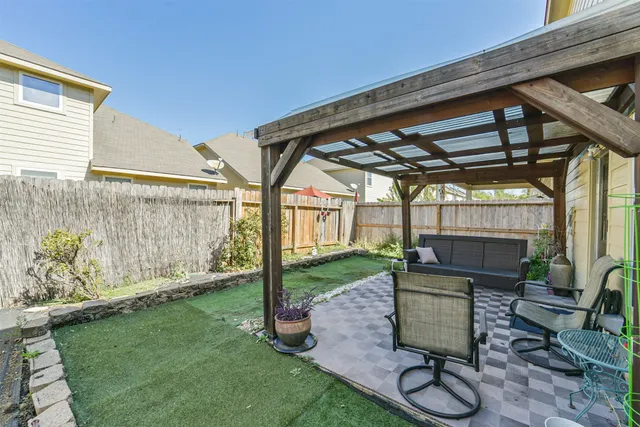 a view of porch with a table and chairs and potted plants