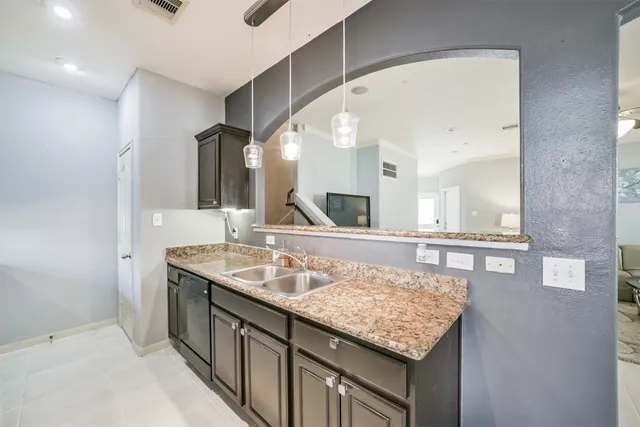 a bathroom with sinks granite and a large mirror