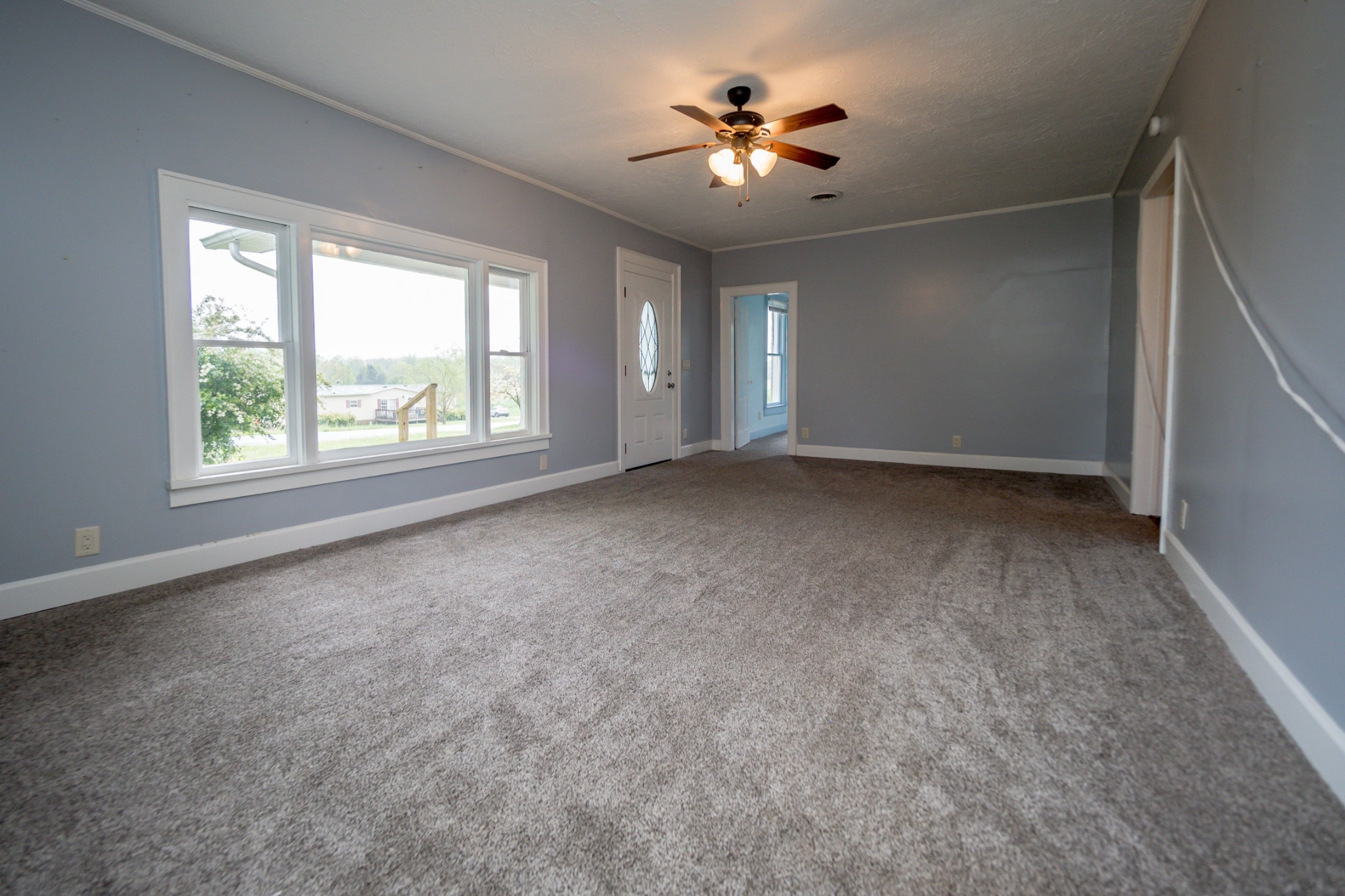 225 Paul Thompson Road Bethpage, TN 37022 - Photo 14 of 14 an empty room with windows and chandelier fan