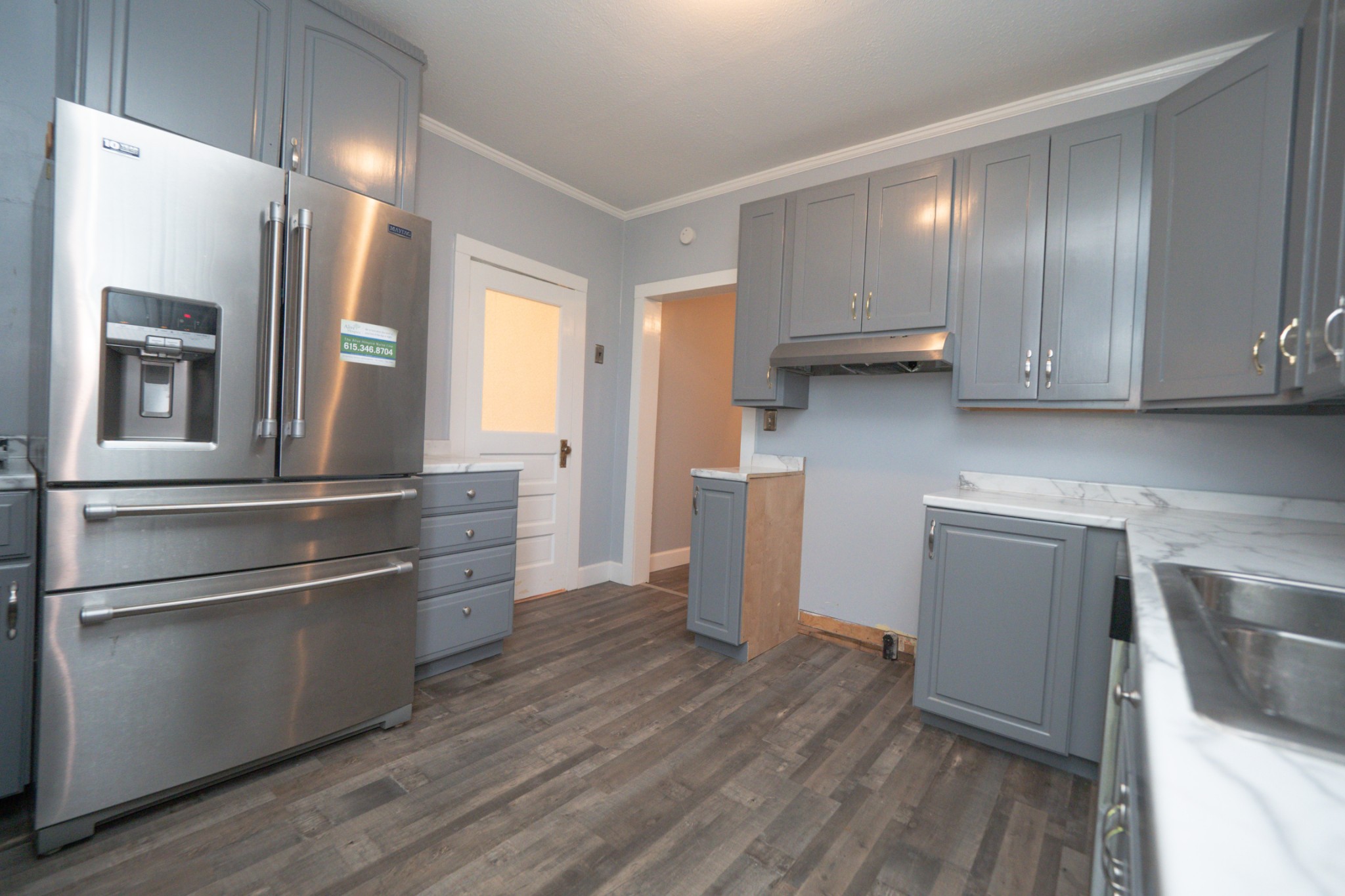 225 Paul Thompson Road Bethpage, TN 37022 - Photo 5 of 14 a kitchen with granite countertop stainless steel appliances and wooden cabinets