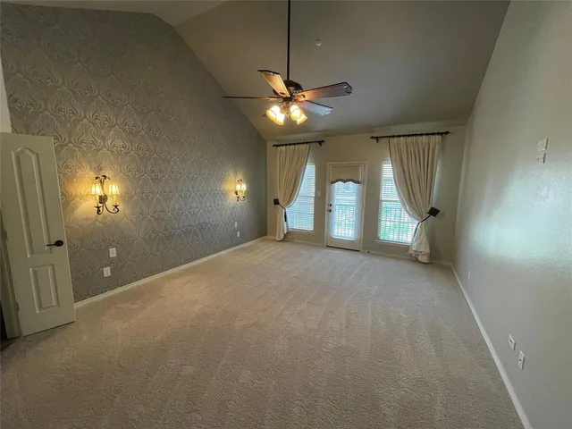 a view of a livingroom with a ceiling fan and window