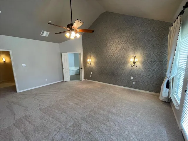 a view of a livingroom with a ceiling fan and window