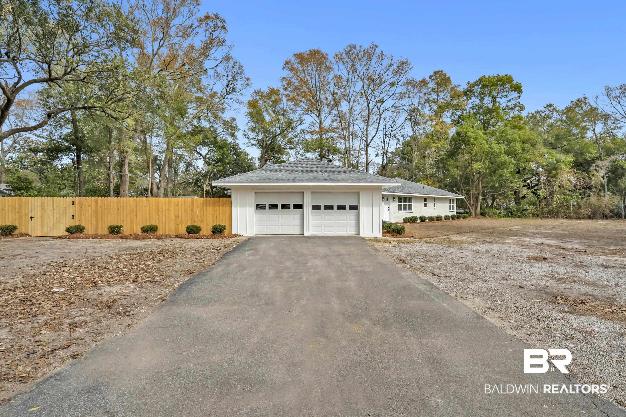 1409 Altair Lane Mobile, AL 36693 - Photo 21 of 23 View of front facade featuring asphalt driveway, a garage, and a shingled roof