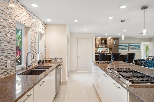a kitchen with a sink stove and refrigerator