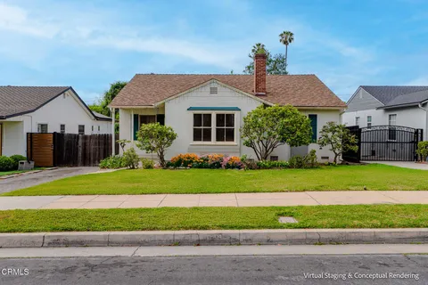 a front view of a house with a garden