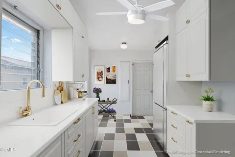 a kitchen with a sink a counter and cabinets
