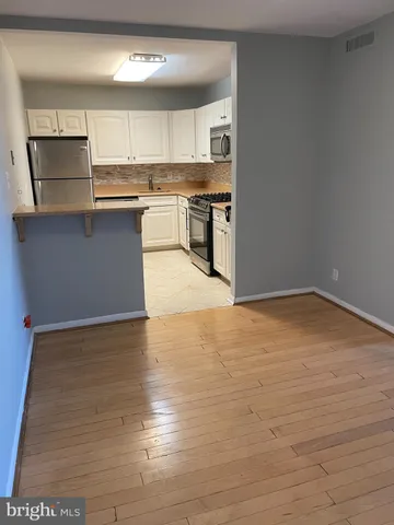 a kitchen with stainless steel appliances granite countertop a sink stove and microwave
