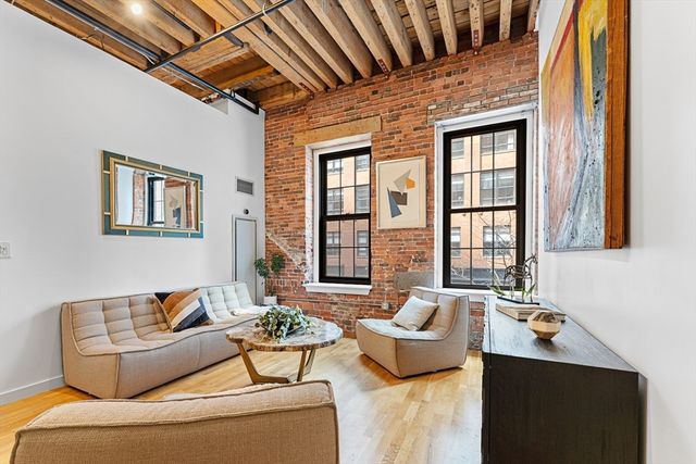 a living room with furniture and windows