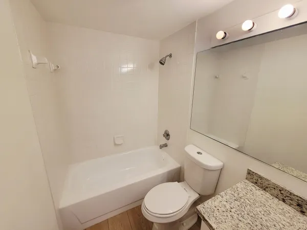 a bathroom with a toilet a sink and bathtub