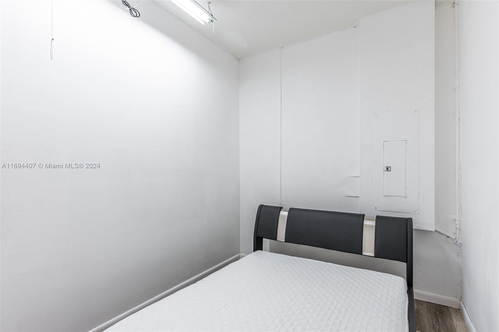 2012 Southeast 15th Street, Unit 1 Homestead, FL 33035 - Photo 5 of 12 a bedroom with a bed and a wall