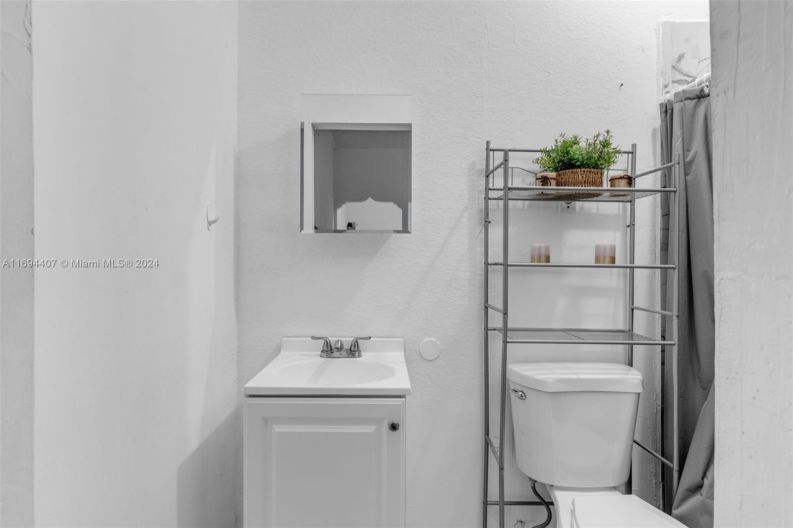 2012 Southeast 15th Street, Unit 1 Homestead, FL 33035 - Photo 6 of 12 a bathroom with a toilet sink and mirror