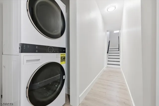 a view of a hallway with washer and dryer