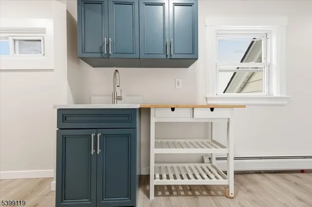 a room with a sink and cabinets