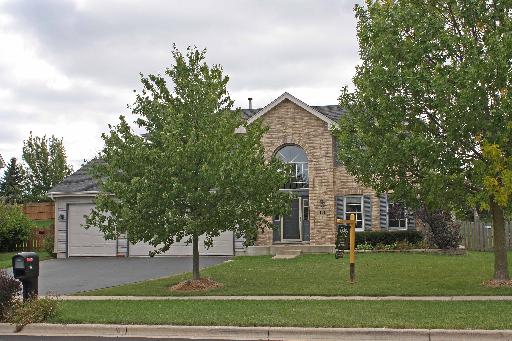 114 Barnes Road Elgin, IL 60124 - Photo 1 of 15 a front view of a house with a garden