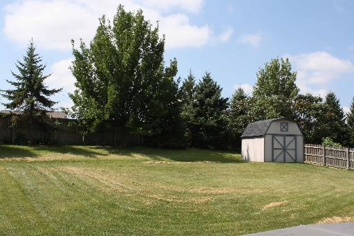 114 Barnes Road Elgin, IL 60124 - Photo 14 of 15 a view of a house with pool and trees in the background