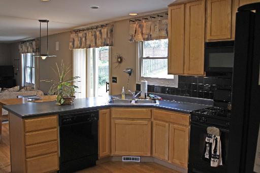 114 Barnes Road Elgin, IL 60124 - Photo 3 of 15 a kitchen with a sink stove and cabinets