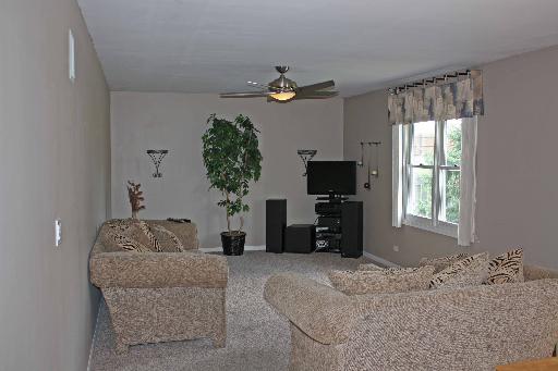 114 Barnes Road Elgin, IL 60124 - Photo 4 of 15 a living room with furniture a window and a flat screen tv