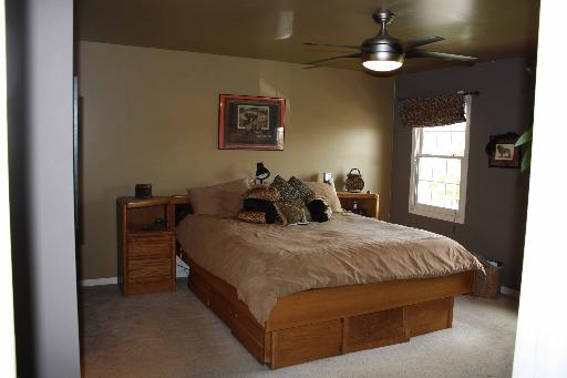 114 Barnes Road Elgin, IL 60124 - Photo 8 of 15 a bed room with a bed and a chandelier