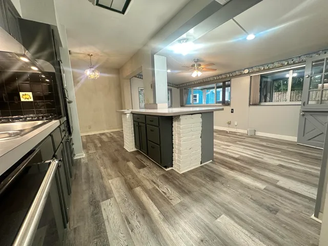 a large kitchen with kitchen island a sink stainless steel appliances and cabinets