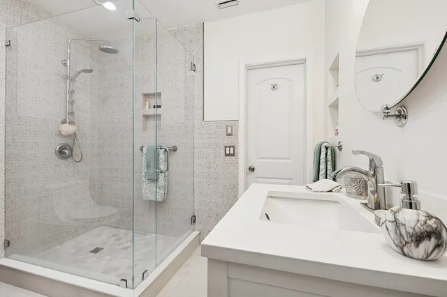 a bathroom with a sink a toilet and shower