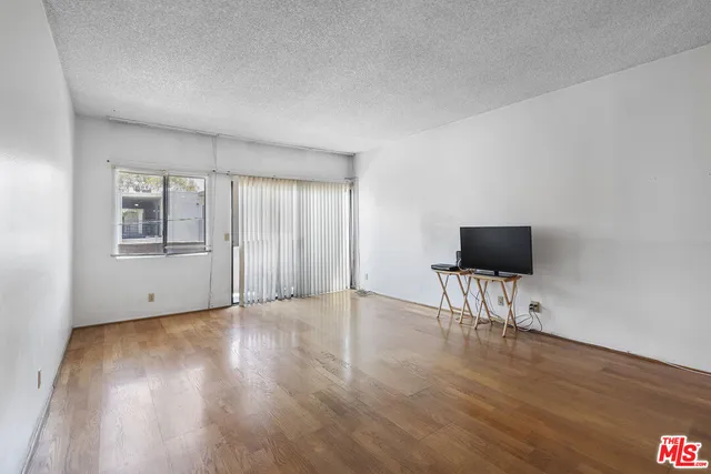 a view of room with hardwood floor and workspace