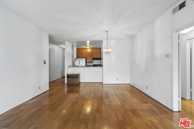 a view of a kitchen with a sink and a refrigerator