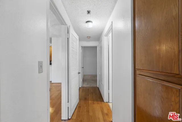 a view of hallway with stairs and wooden floor