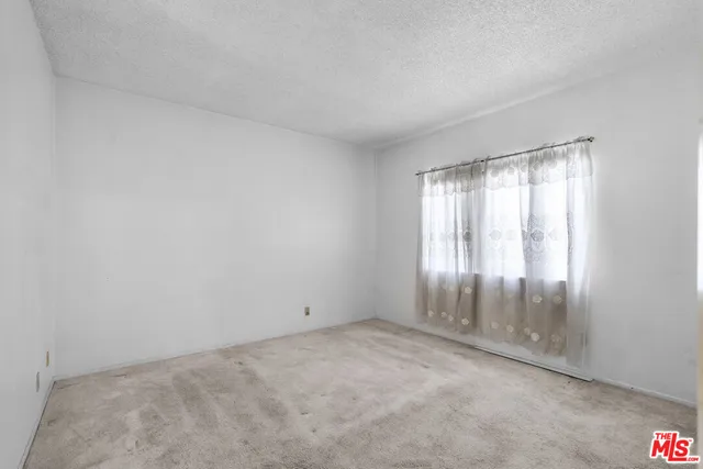 an empty room with an empty space and windows