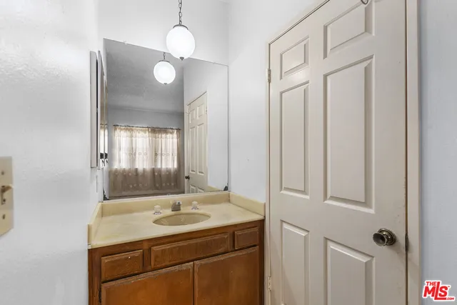 a bathroom with a shower curtain a toilet and a shower