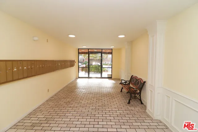 a view of a room with furniture and floor to ceiling window