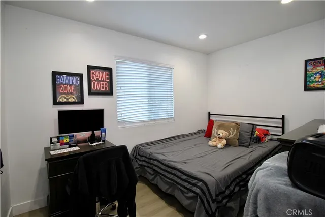 a bedroom with a bed and a computer on a table