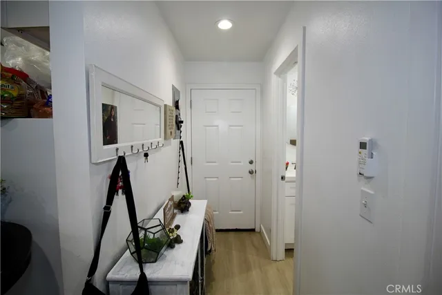 a view of a hallway with living room and stairs