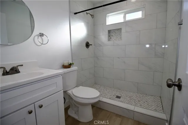 a bathroom with a toilet sink and shower