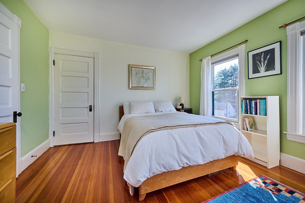 16 South Sunset Avenue Amherst, MA 01002 - Photo 19 of 42 a bedroom with a bed and a wooden floor