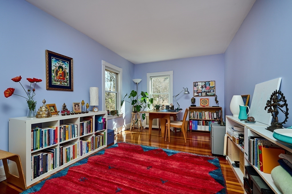 16 South Sunset Avenue Amherst, MA 01002 - Photo 20 of 42 a living room with lots of books and baby bed
