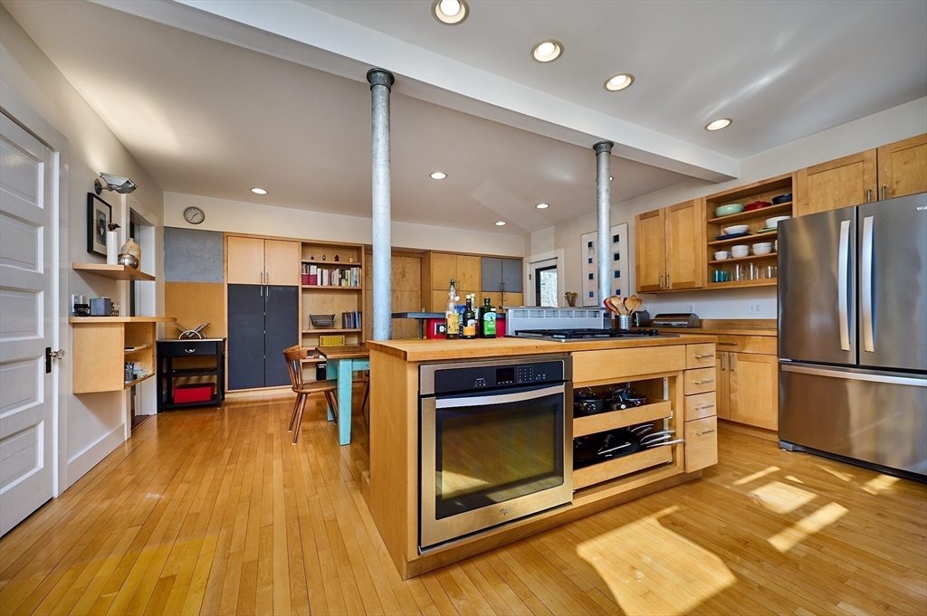 16 South Sunset Avenue Amherst, MA 01002 - Photo 8 of 42 a kitchen with stainless steel appliances granite countertop a refrigerator oven a sink dishwasher and white cabinets with wooden floor