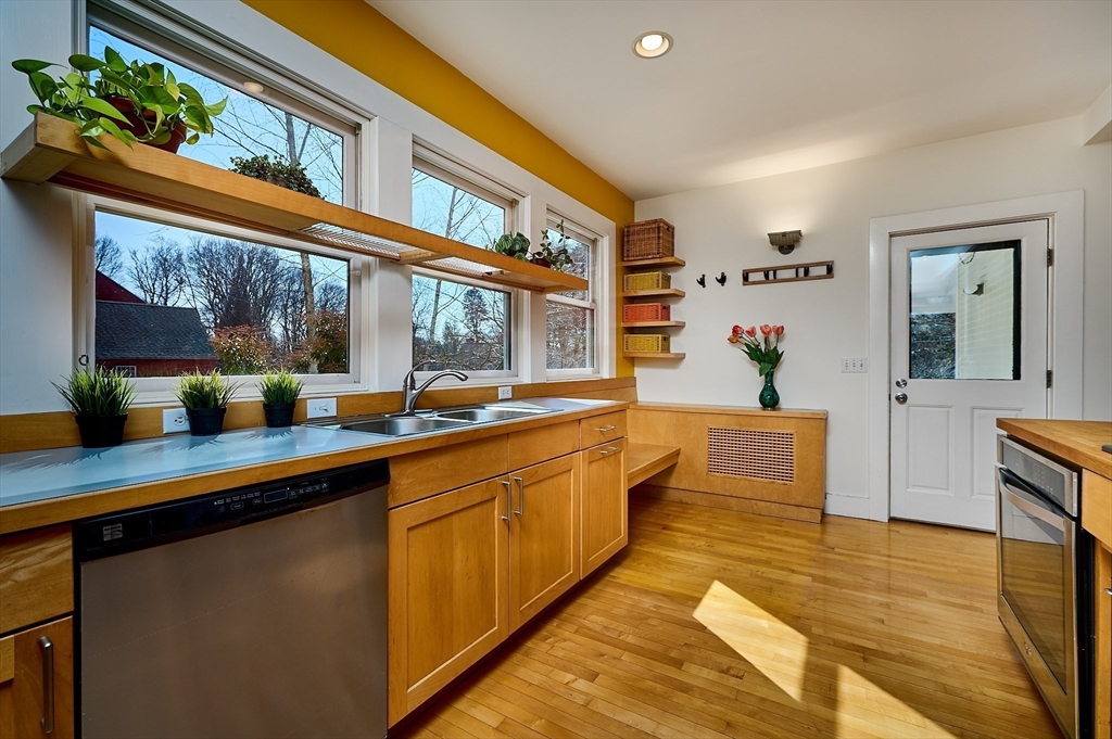 16 South Sunset Avenue Amherst, MA 01002 - Photo 9 of 42 a large kitchen with stainless steel appliances a large counter top a stove and a wooden floors