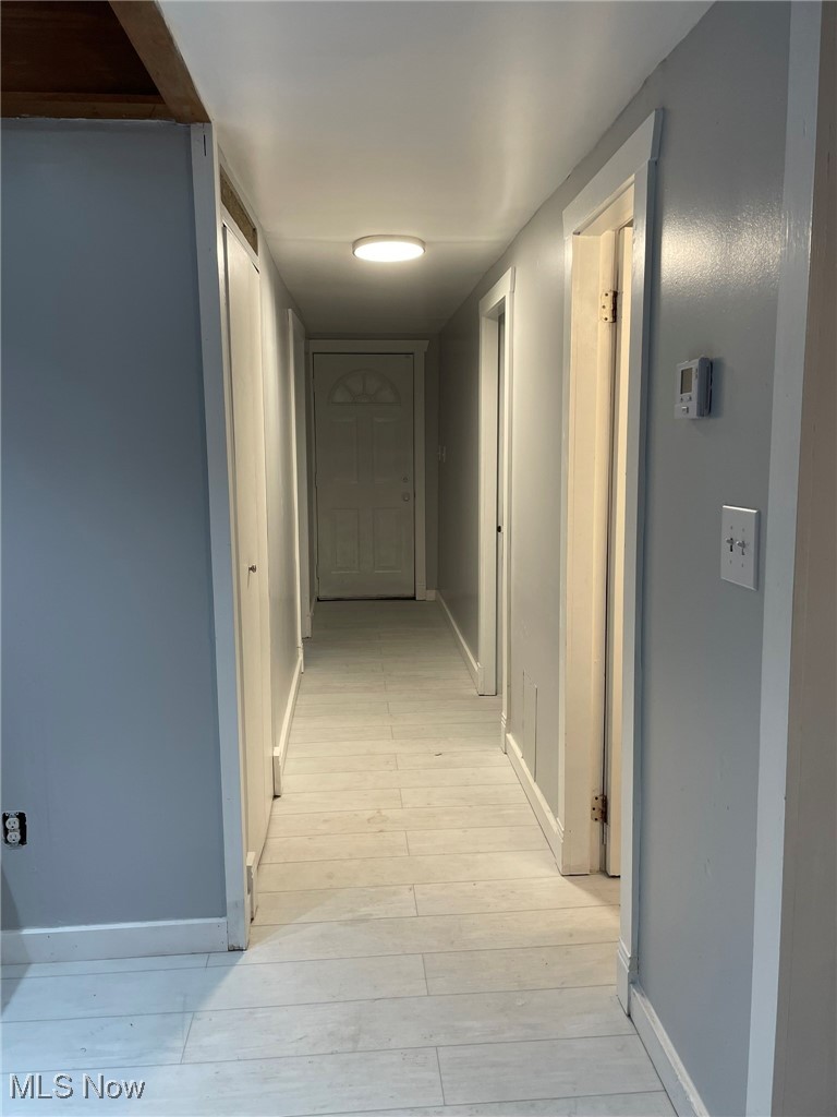 940 Long Shadow Lane Rome, OH 44085 - Photo 13 of 23 Hallway with baseboards and light wood-type flooring