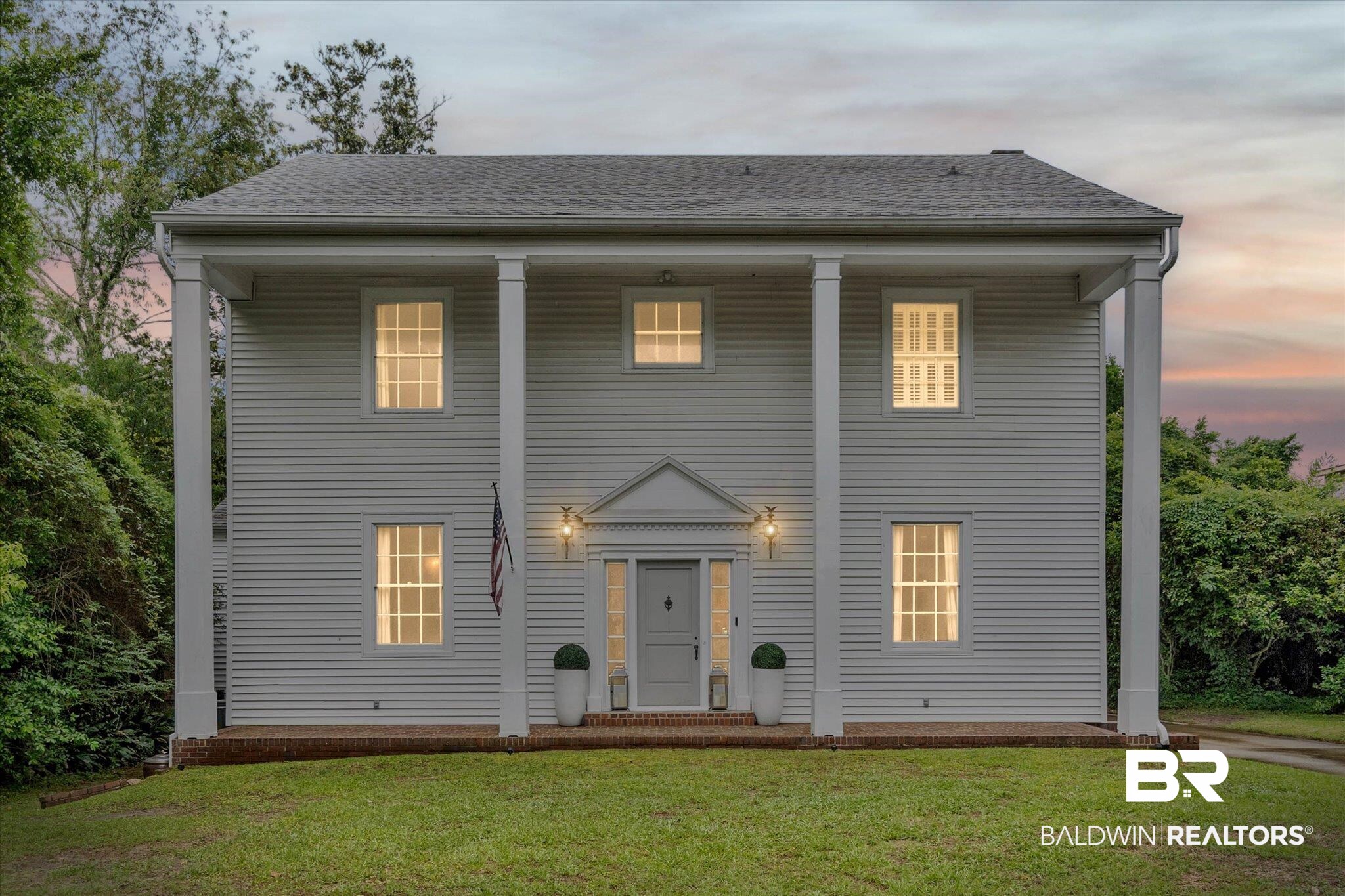 3863 Old Shell Road Mobile, AL 36608 - Photo 1 of 48 Colonial-style facade featuring prominent white columns, horizontal siding, and a gabled portico entry