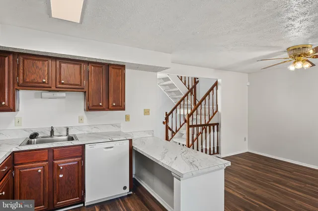 a kitchen with wooden cabinets and a sink