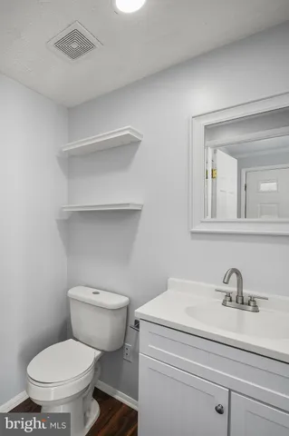 a bathroom with a toilet sink and mirror