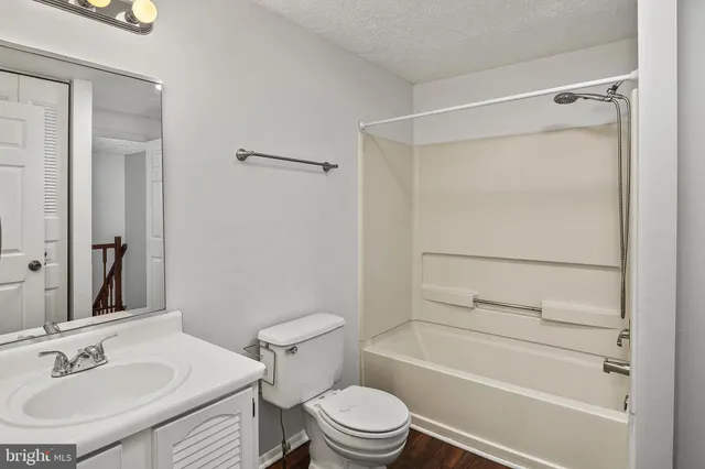 an empty room with fan and entryway