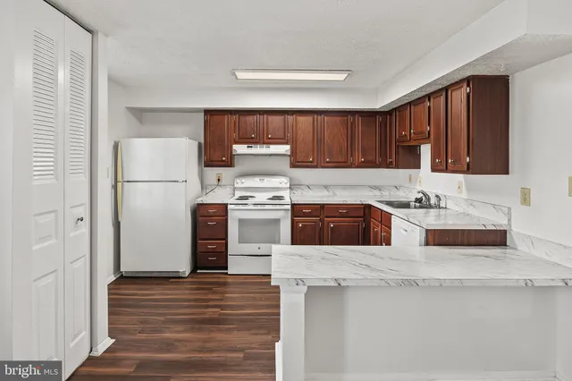 a kitchen with stainless steel appliances granite countertop a refrigerator sink and cabinets