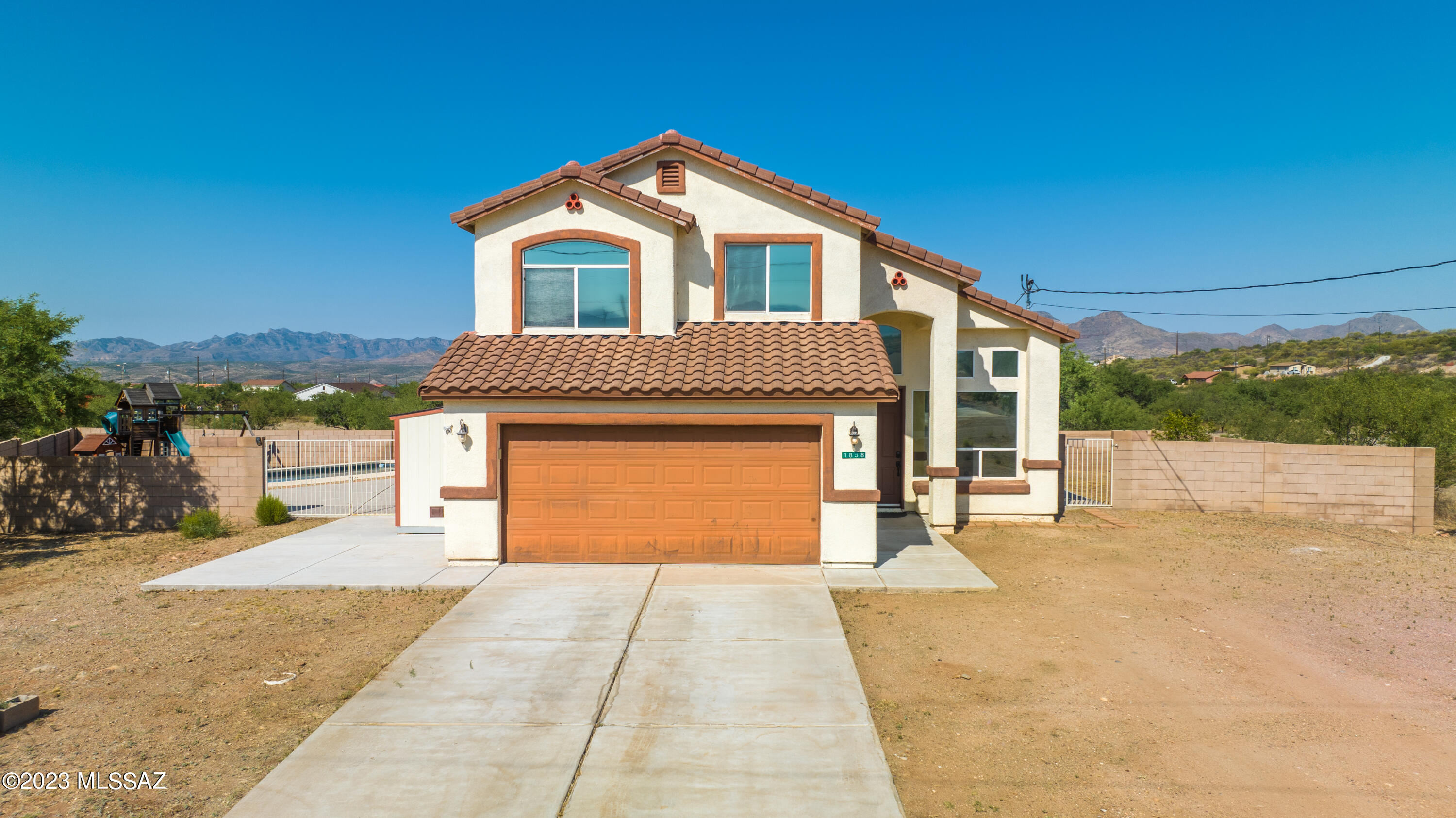 1858 Tijuana Court Rio Rico, AZ 85648 - Photo 3 of 33 a front view of a house with a yard and garage