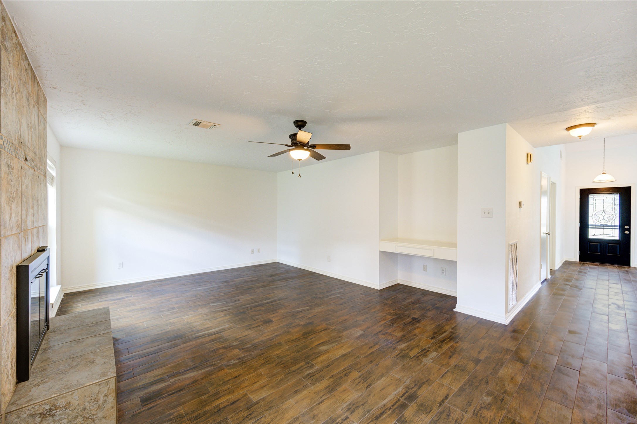 3639 Fir Forest Drive Spring, TX 77388 - Photo 16 of 44 a view of a kitchen with wooden floor a ceiling fan and a window