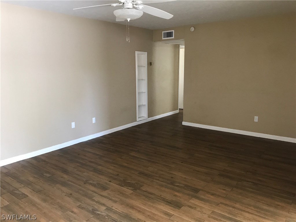 20 Alabama Road South Lehigh Acres, FL 33936 - Photo 3 of 13 a view of an empty room with wooden floor